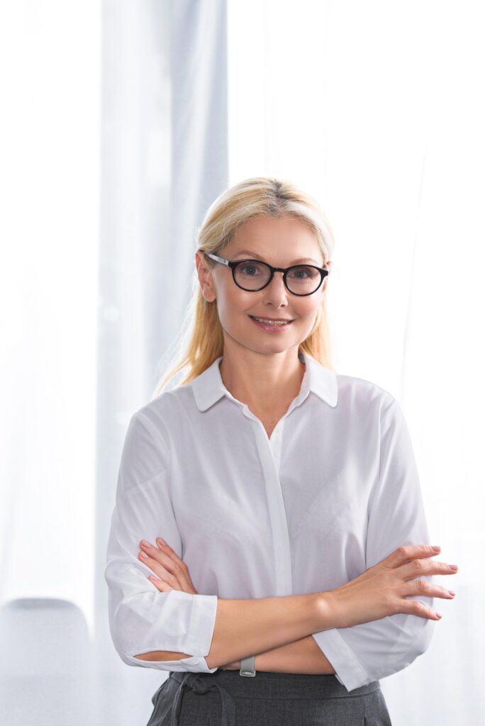 portrait of female therapist in eyeglasses with crossed hands